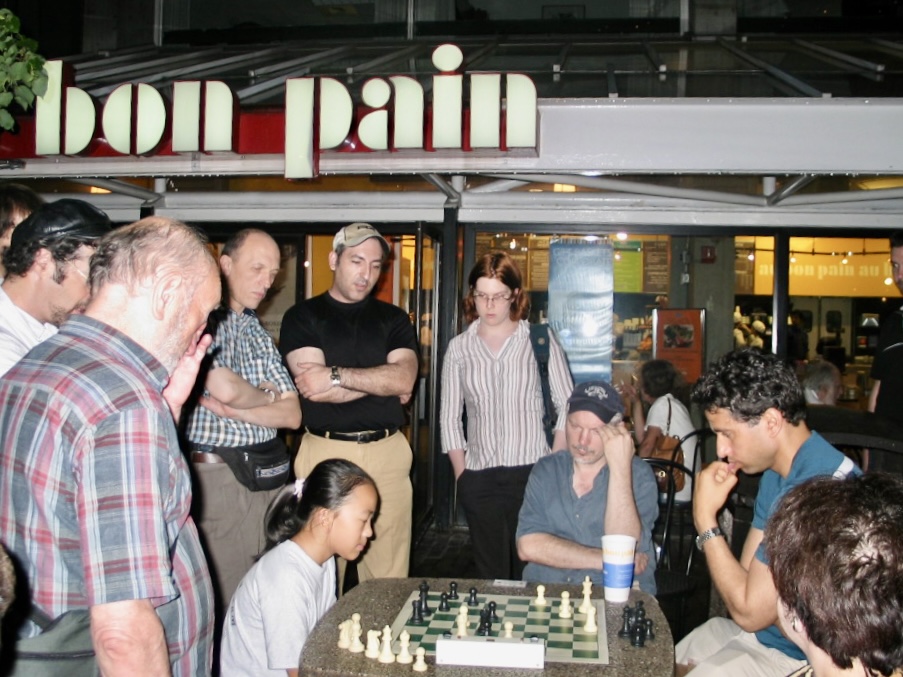 Yuanling Yuan playing chess at Harvard Square in Cambridge 