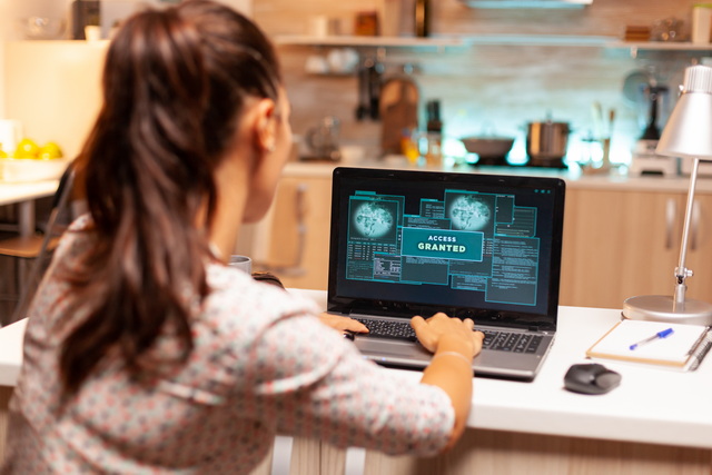 Employee using a laptop with an access granted notice on the screen