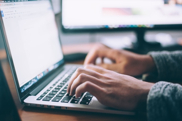 Employee or contractor typing on a laptop 