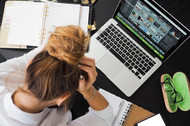 Frustrated employee using a laptop