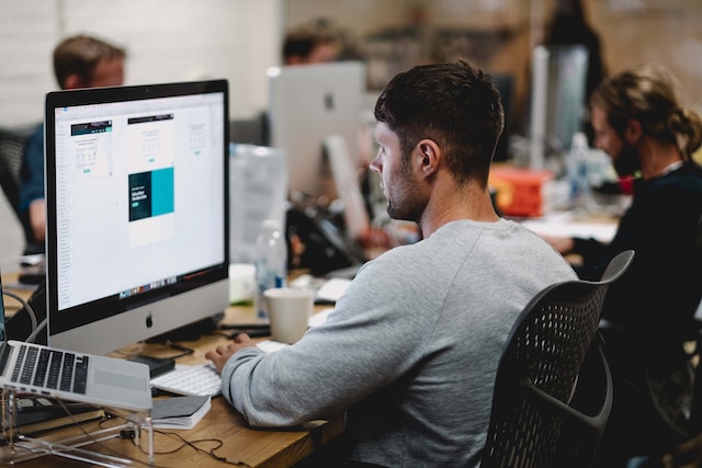 People working on computers in an open office environment