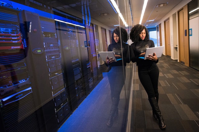 Woman working on a laptop in a hallway