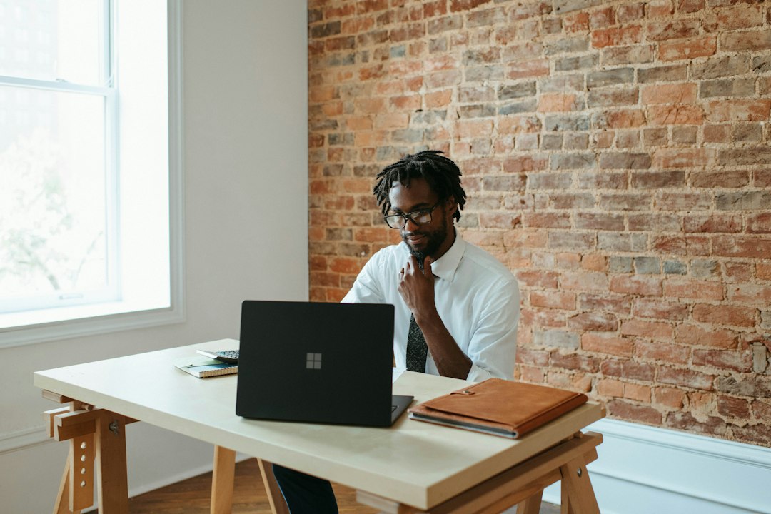 person using laptop at desk  