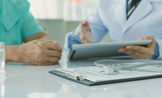 Provider reviewing patient healthcare data with patient on a tablet