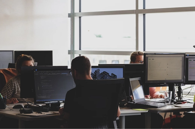 Open office environment where coworkers are working on computers