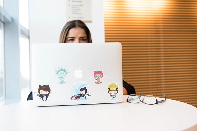 Person working alone at a table on a laptop